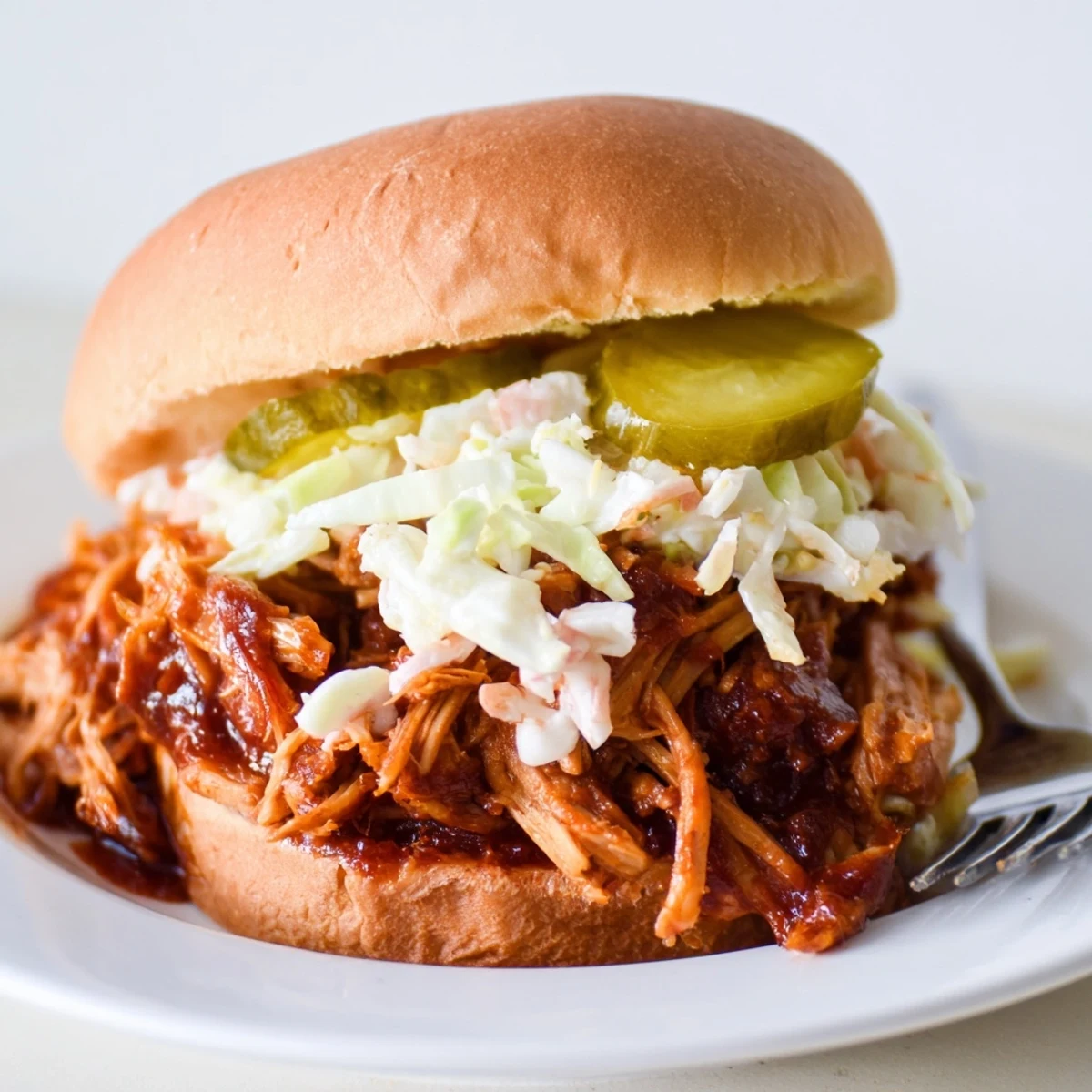 Smoky pulled pork simmering in savory barbecue sauce, perfect for a comforting lunch.