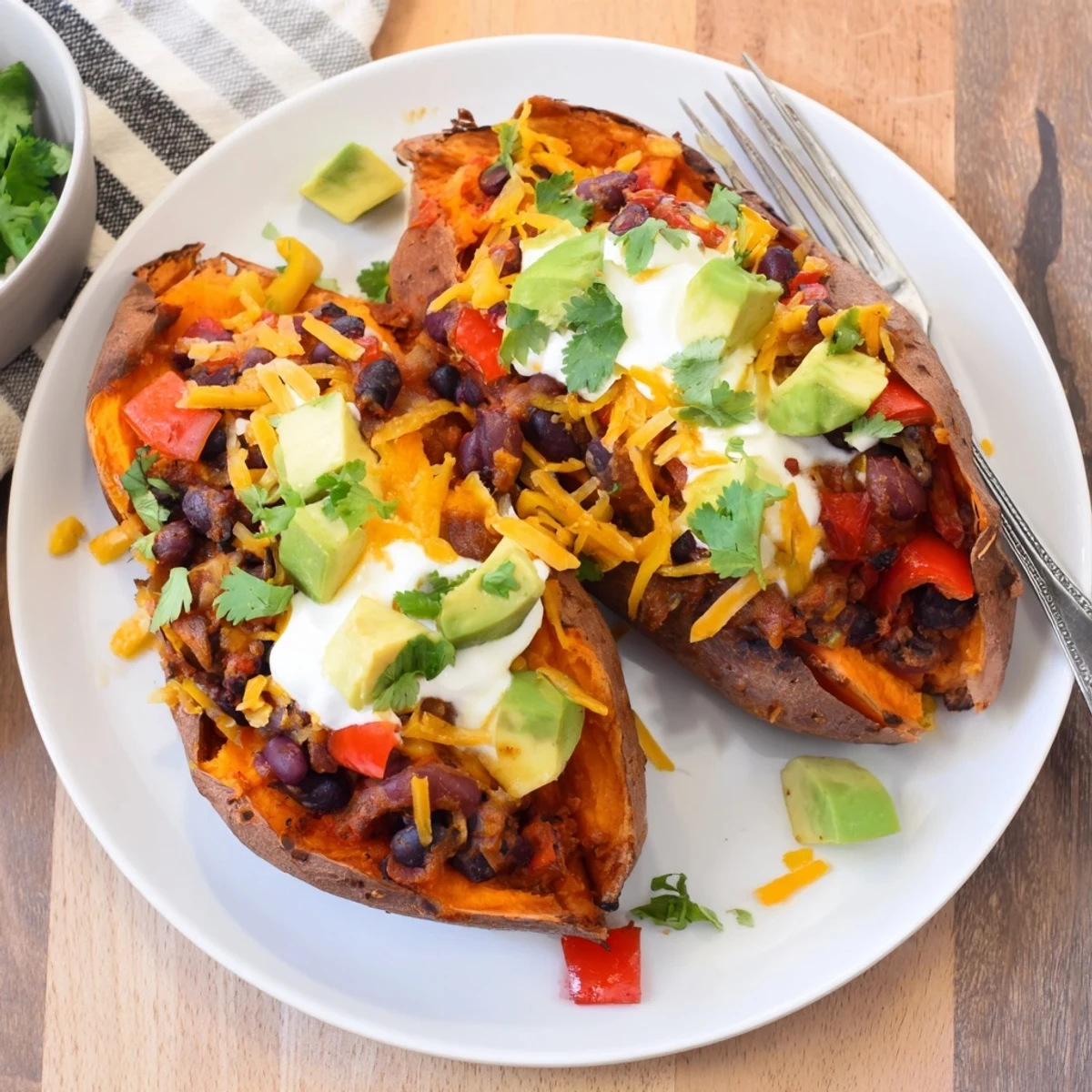 Savory baked sweet potato chili boats, bursting with colorful chili, ready for a delicious dinner.