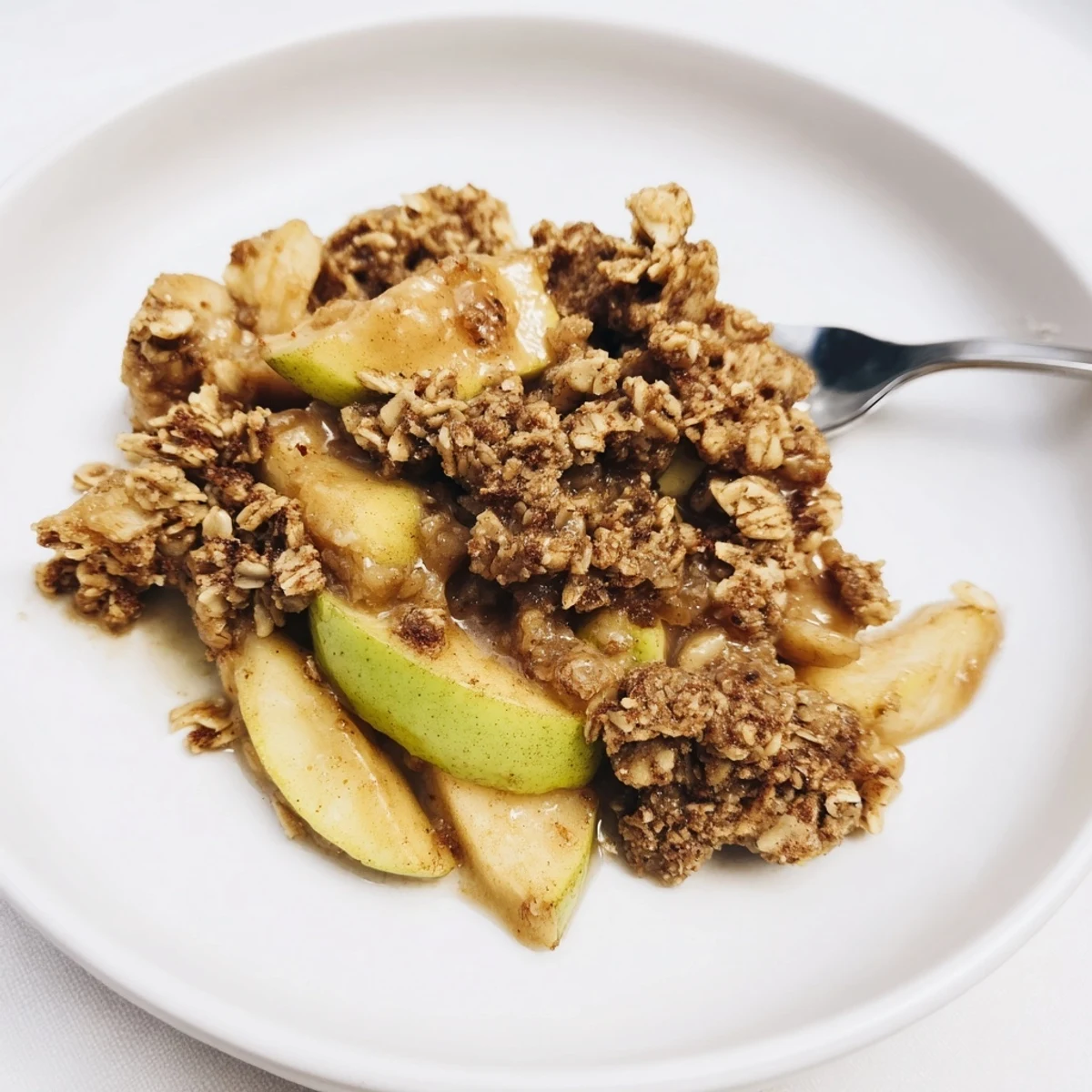 Warm Best Apple Crisp, bubbling apples beneath a golden oat-almond crumble, perfect for dessert.