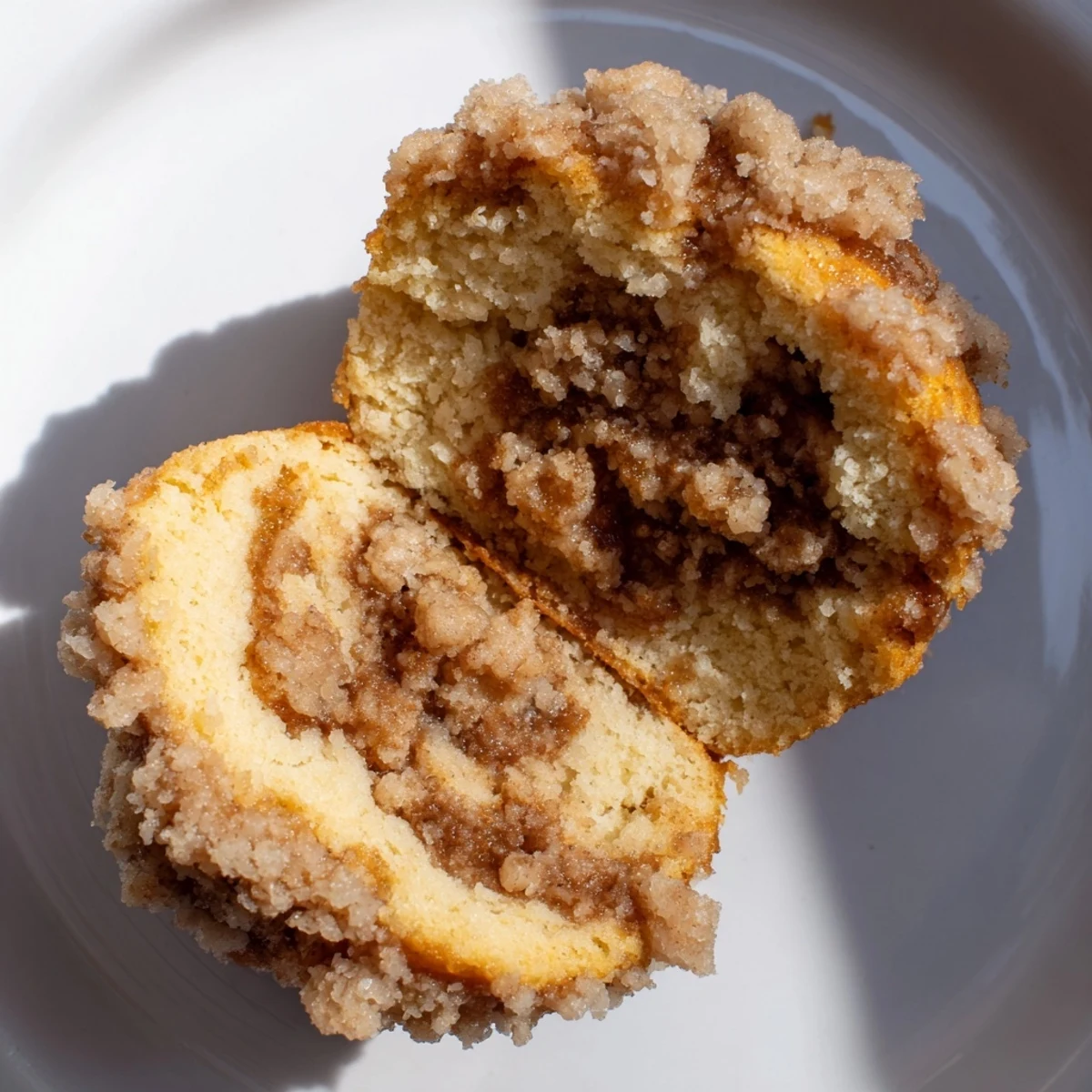 Fluffy Lightened Christmas Coffee Cake Muffins, baked golden brown, topped with a sweet, crumbly streusel.