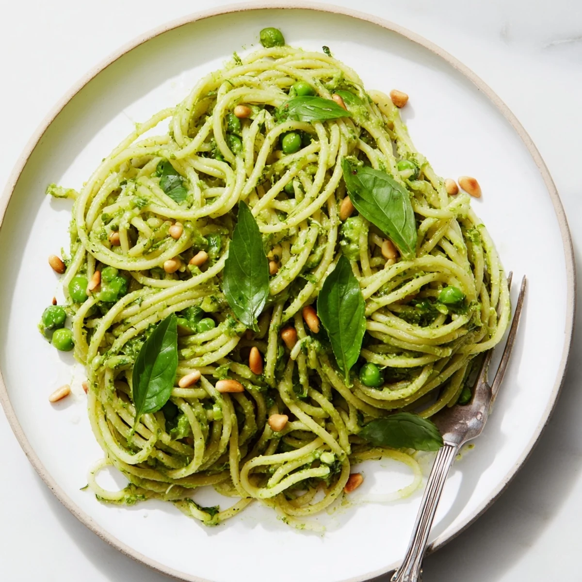 Bright green Green Pea & Spinach Elf Green Protein Pasta, ready to eat, with lemon zest garnish, smells amazing.