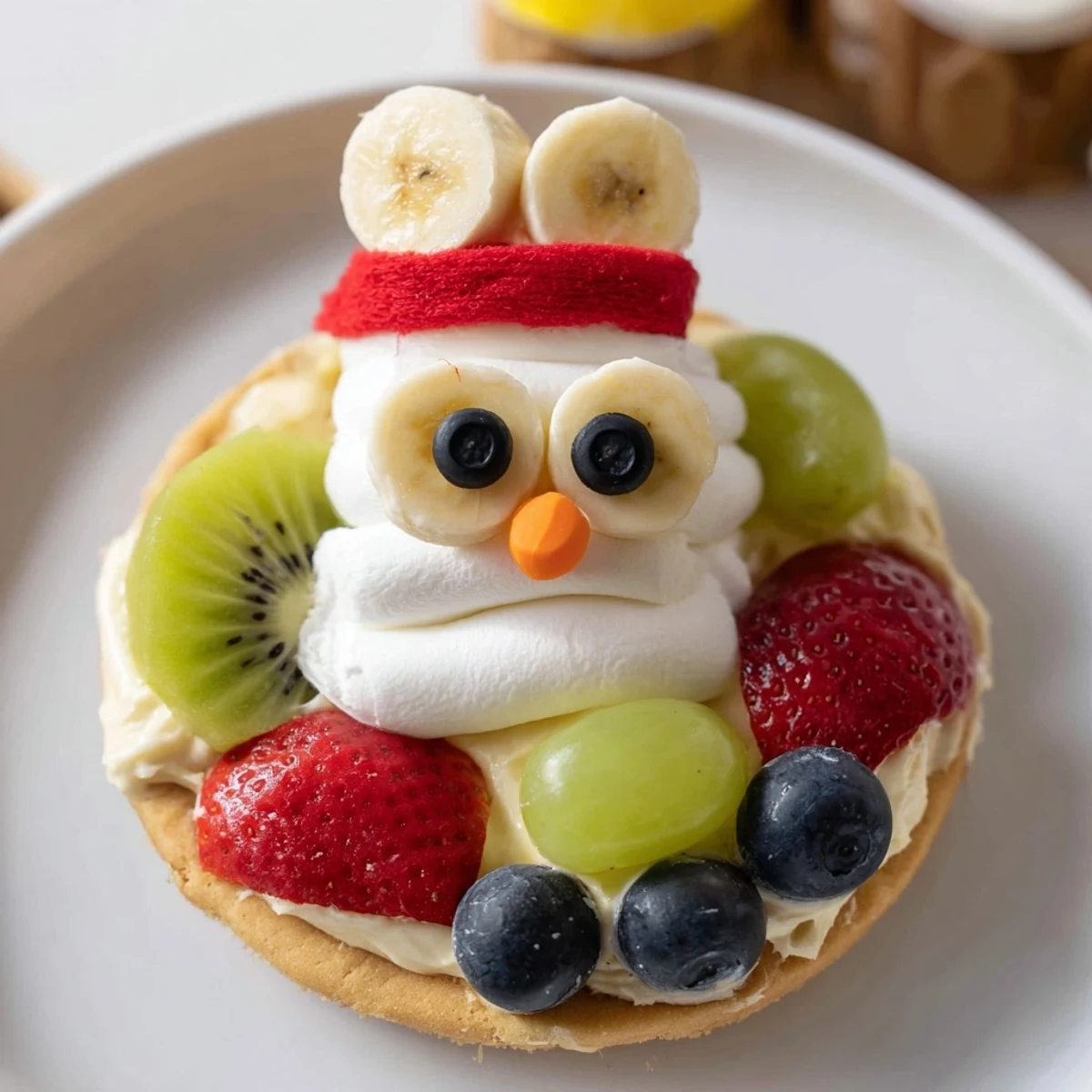 Festive Melting Snowman Fruit Pizza, featuring colorful fruit and cream cheese frosting, ready to serve and enjoy.
