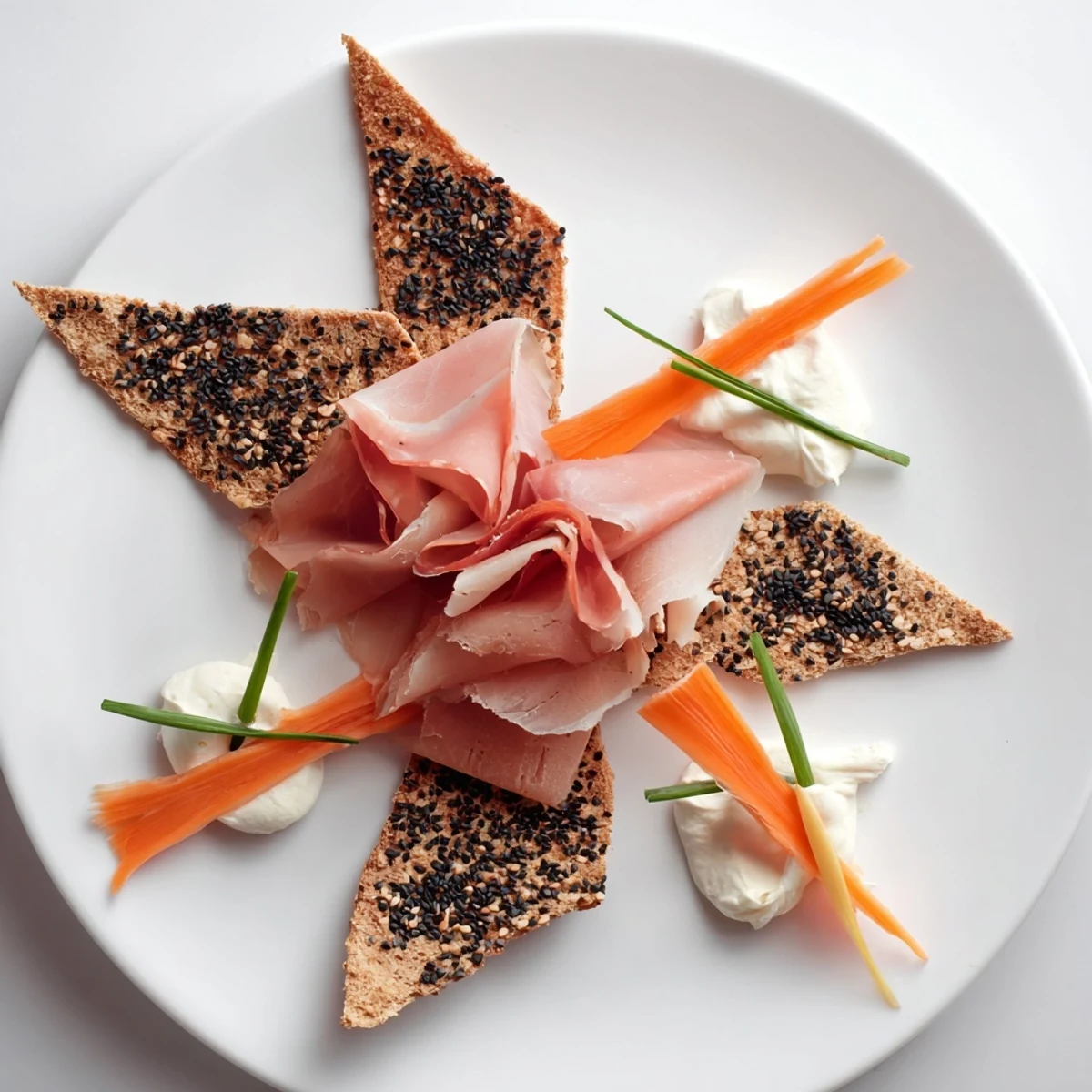 A visually stunning Paper Crane appetizer featuring folded meats over crisp triangular crackers, ready to eat!