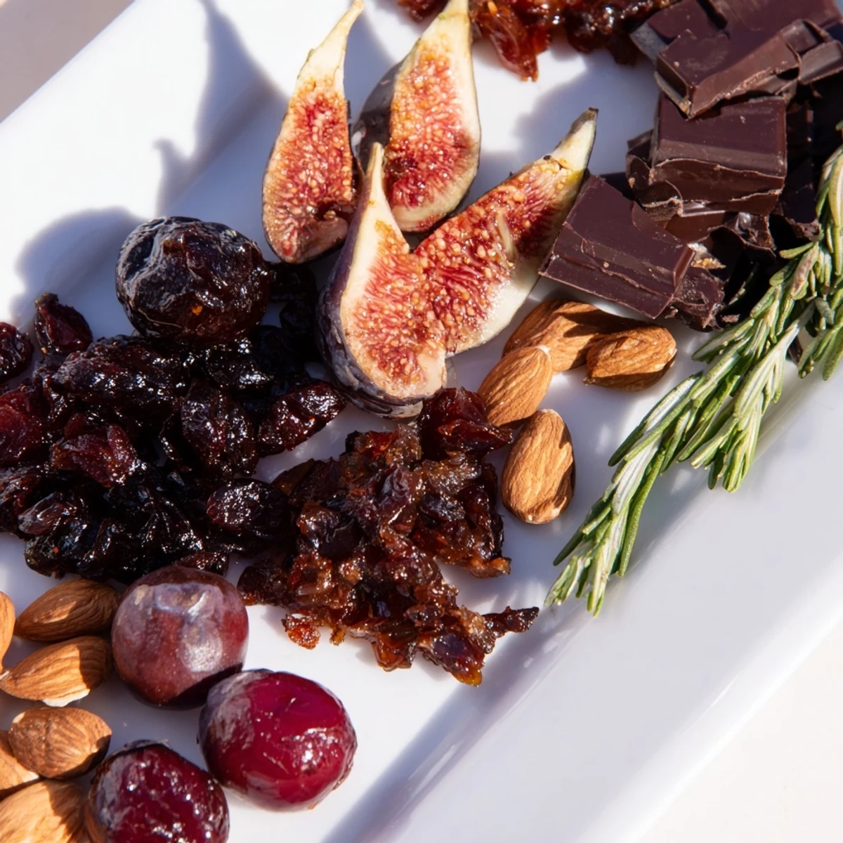 A beautifully arranged Winter Solstice Board, showcasing olives, figs, Brie, and pears.