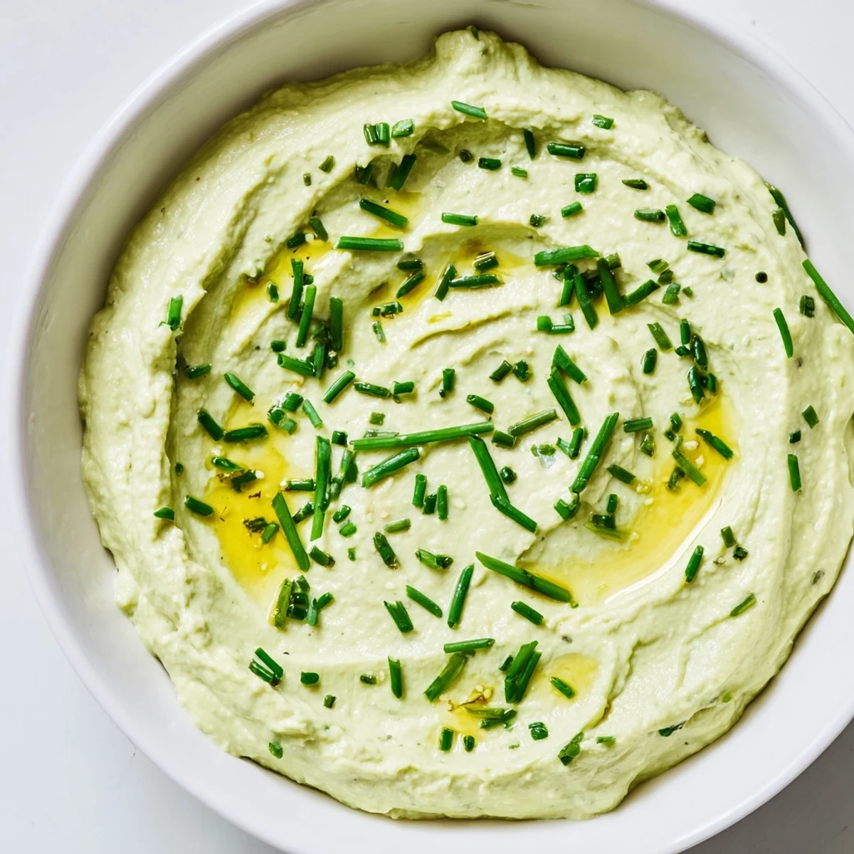 Creamy avocado cottage cheese dip, perfectly blended, ready to serve with fresh veggie sticks.