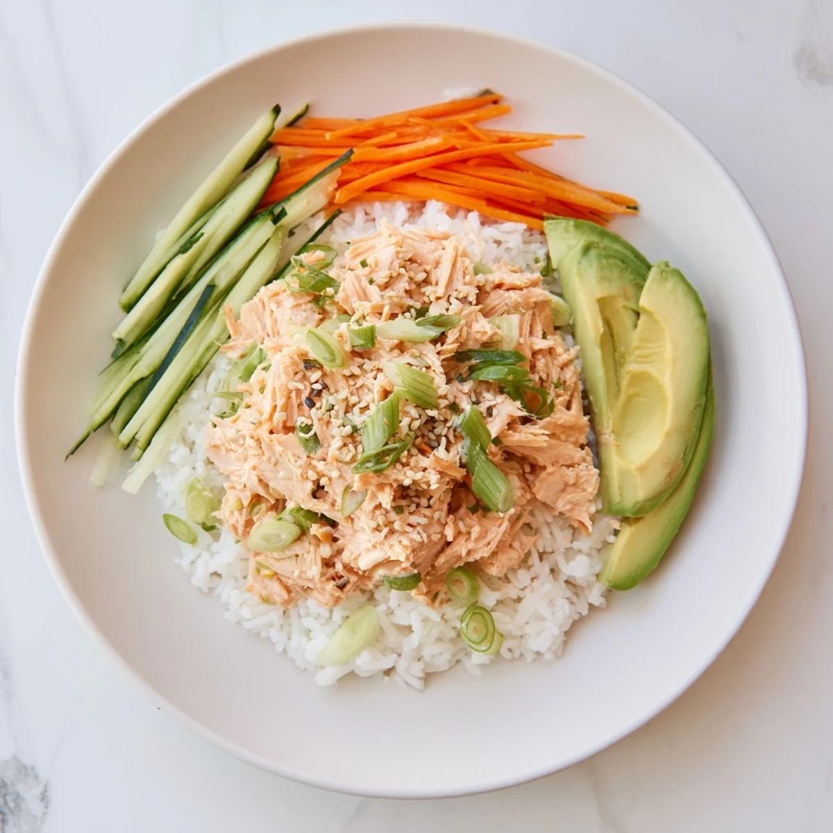 Steaming Spicy Canned Salmon Rice Bowl brimming with colorful veggies and creamy sriracha mayo.