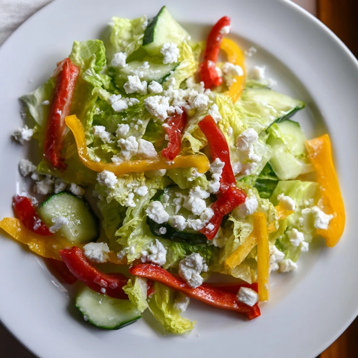 A colorful Bella Hadid Salad brimming with fresh veggies, feta, and lemon dressing, ready to enjoy.