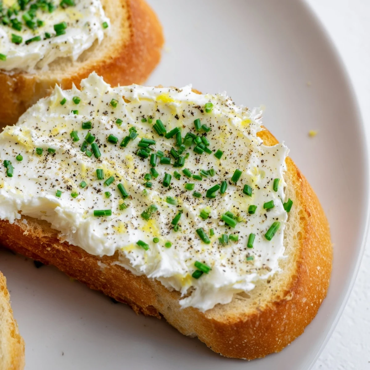 Toasted baguette slices with smooth vodka-infused butter, served warm and ready for appetizer pairing with optional smoked salmon toppings.