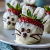 Sweet strawberry bunnies with pink candy melt noses, chocolate drizzle, and cute edible marshmallow ears for Easter fun.