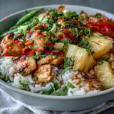 Tropical chicken and pineapple rice bowls with tender chicken, crisp vegetables, and toasted coconut, served over creamy coconut-infused jasmine rice.  