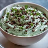 Creamy mint chocolate chip dip with shamrock sprinkles, perfect for St. Patrick's Day parties and festive gatherings.