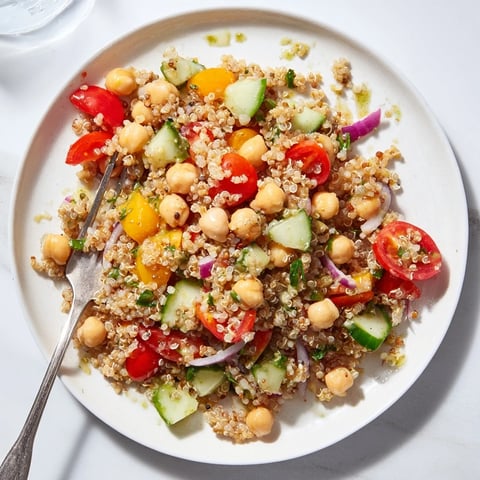 Colorful quinoa salad with chickpeas and creamy avocado dressing, perfect for a nutritious meal.  