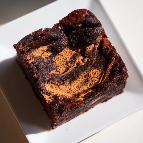 Warm, dark Pumpkin Workout Brownies, fudgy and perfect for a post-gym treat with a sprinkle of cocoa.
