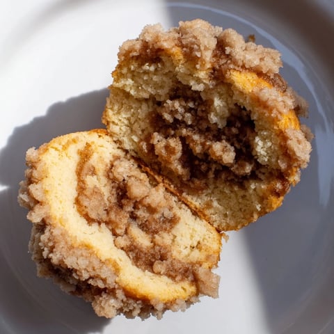 Fluffy Lightened Christmas Coffee Cake Muffins, baked golden brown, topped with a sweet, crumbly streusel.