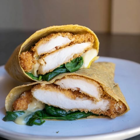 Golden Chicken Piccata Crunch Wrap, sizzling and crisp, with melting cheese and tangy sauce inside.