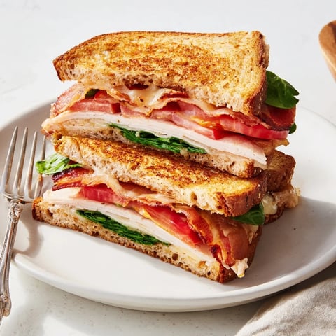 Golden, crispy Turkey Bacon, Spinach & Tomato Protein Grilled Cheese, perfect for a satisfying lunch or dinner.
