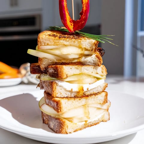 Golden-brown Brie, Apple & Honey Christmas Candle Grilled Cheese, oozing with melted cheese and sweet honey.