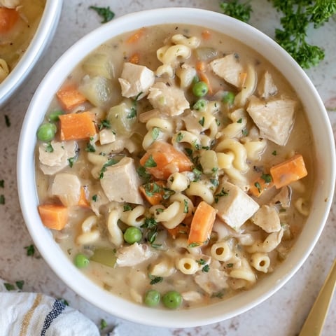 Chicken Pot Pie Pasta Soup: a hearty bowl of creamy soup with tender chicken and vegetables.