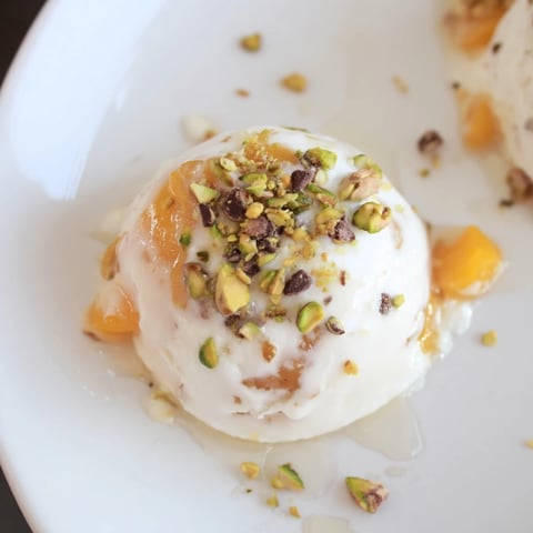 Frozen peach yogurt bites, creamy and swirled with peach pieces, are a cool summer dessert.