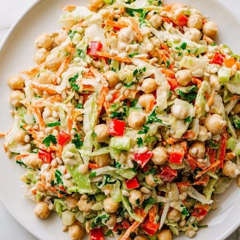 Vibrant chickpea salad with crisp veggies and creamy tahini dressing, a perfect light lunch.