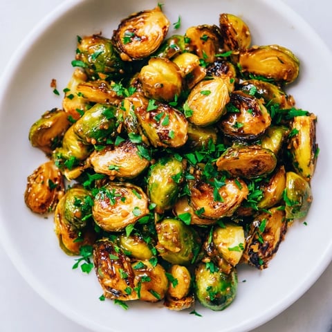 Golden-brown Honey Mustard Glazed Brussels Sprouts sit ready to serve, a flavorful side dish.