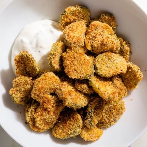 Golden-brown crispy fried pickles, a southern appetizer ready to dip in creamy ranch dressing.
