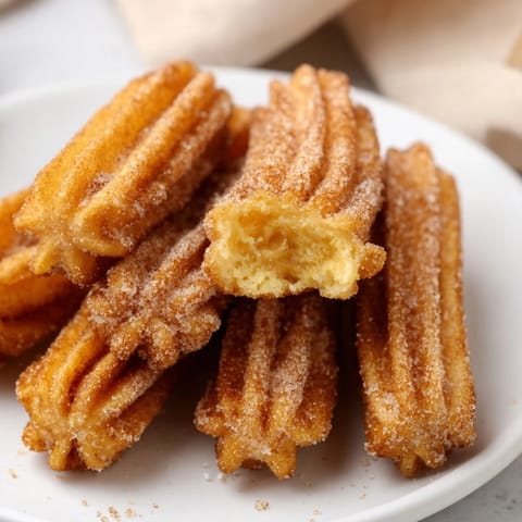 Delicious classic cinnamon sugar churro bites, perfect for snacking or dessert.  