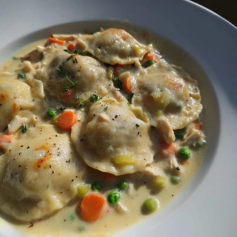 Homemade Chicken and Dumplings Casserole, served hot, boasting fluffy dumplings atop creamy chicken.