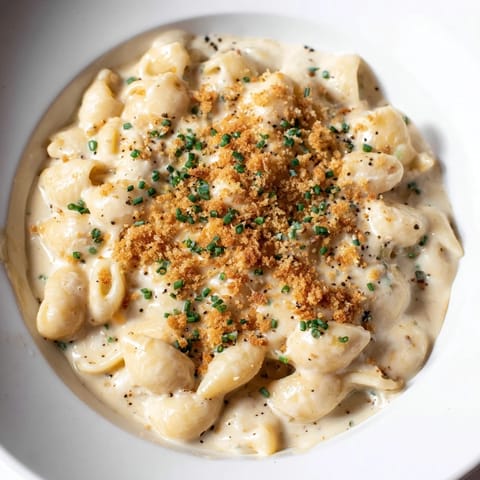 A close-up shot of creamy Cottage Cheese Mac and Cheese, with golden, melted cheese, ready to eat.