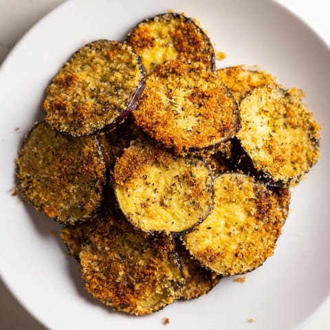 These crunchy Crispy Eggplant Parmesan Chips are lightly coated and baked to a perfect savory crispness.