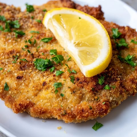 Crispy breading surrounds a juicy interior on this delicious Austrian Wiener Schnitzel.
