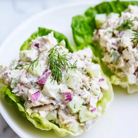 Close-up of Dill Pickle Chicken Salad Lettuce Cups showing chopped pickles, fresh dill, and juicy shredded chicken.  