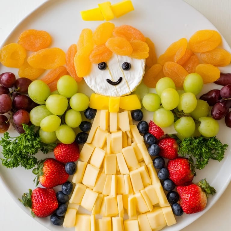 Visually stunning Cherub Angel Snack Tray with a brie face, grapes for wings, and cheddar cheese body; ready to serve.