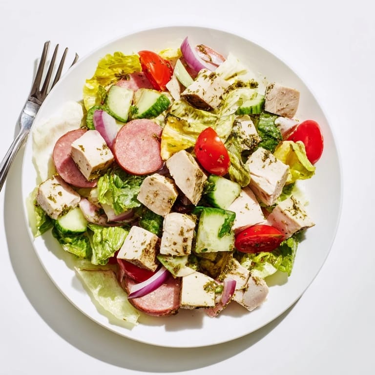 Freshly tossed Italian Deli Chopped Chicken Salad with cherry tomatoes, cucumber, and red onion, ready to serve.